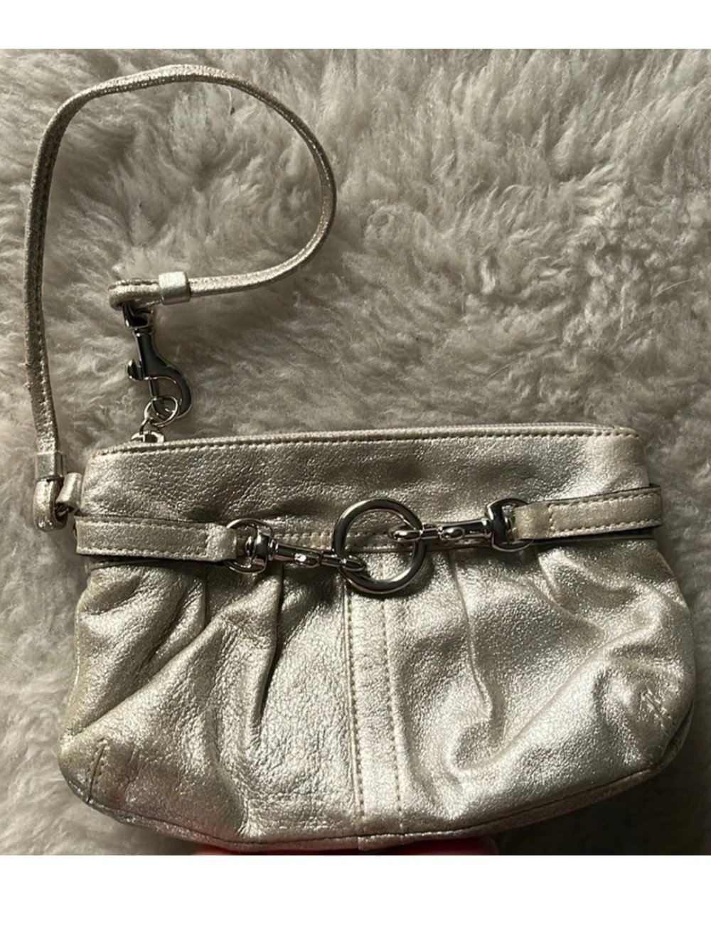 Silver metallic COACH Mini wristlet with studded back and spring latch hardware